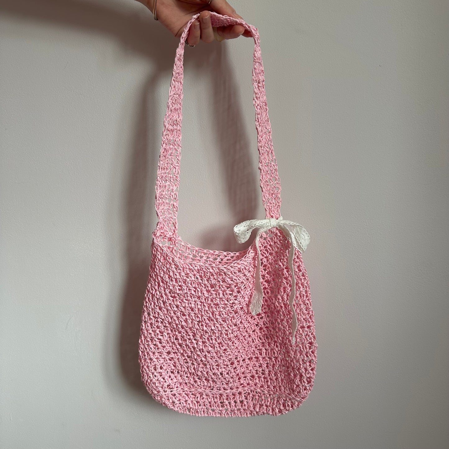 Handmade baby pink crochet straw bag with white lace bow