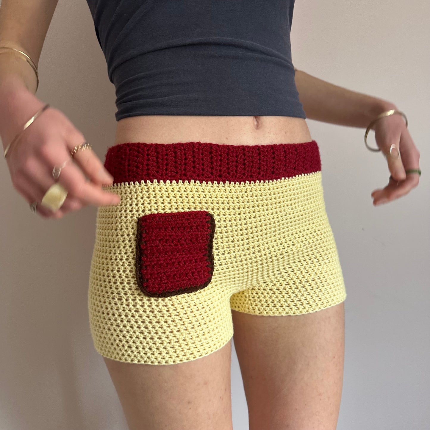 Handmade crochet shorts in pastel yellow, dark red and brown with pocket