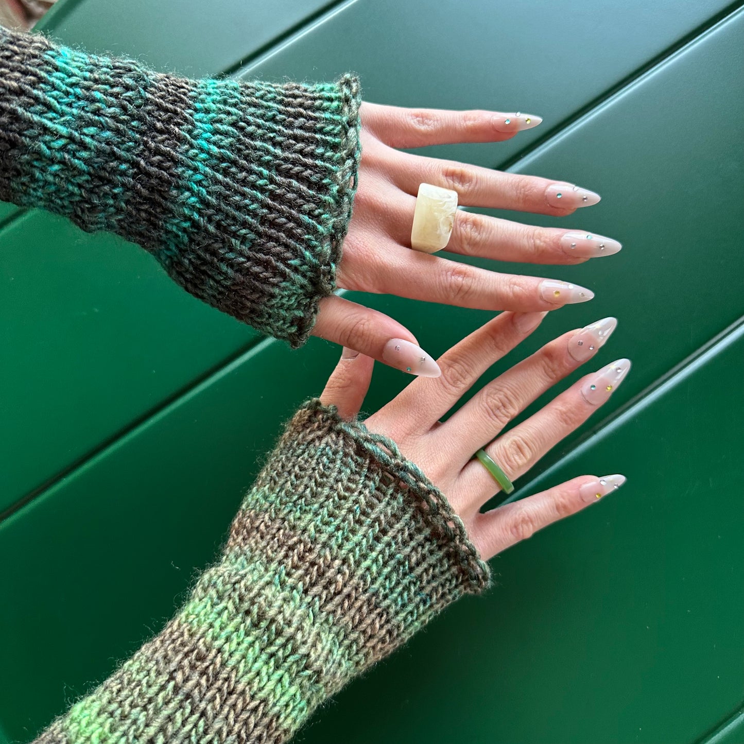 Handmade knitted ombré green hand warmers