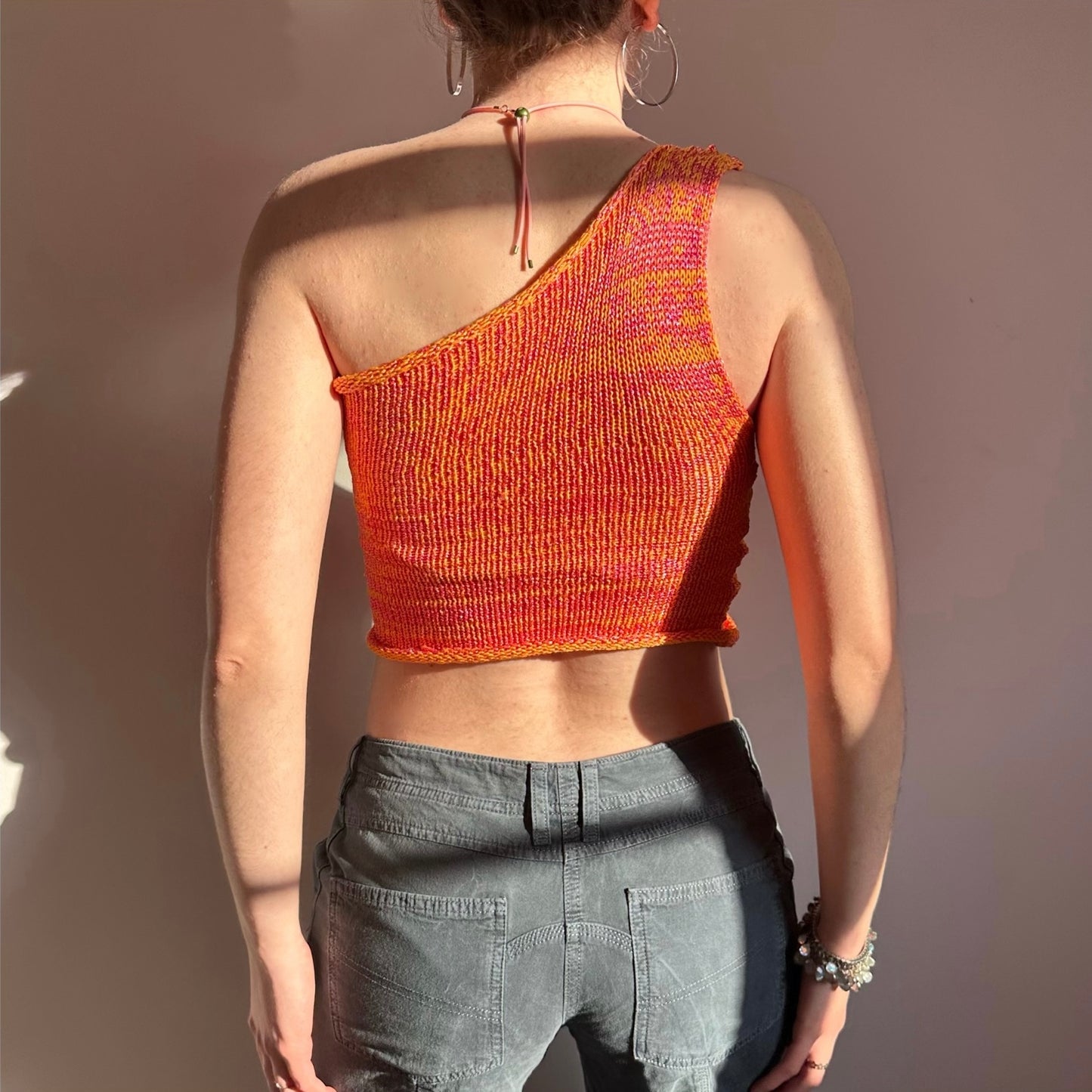 Handmade knitted metallic asymmetrical one shoulder top in orange and pink
