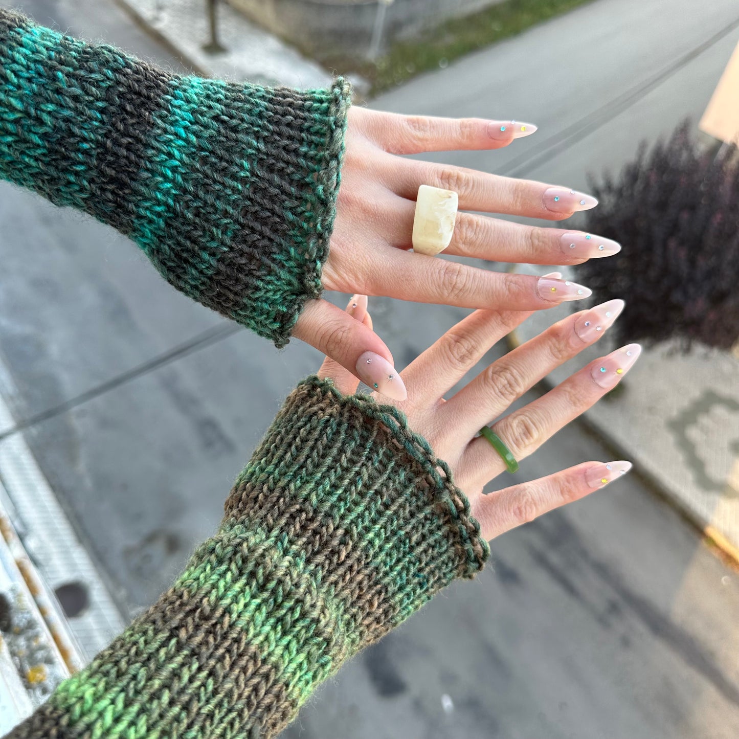 Handmade knitted ombré green hand warmers