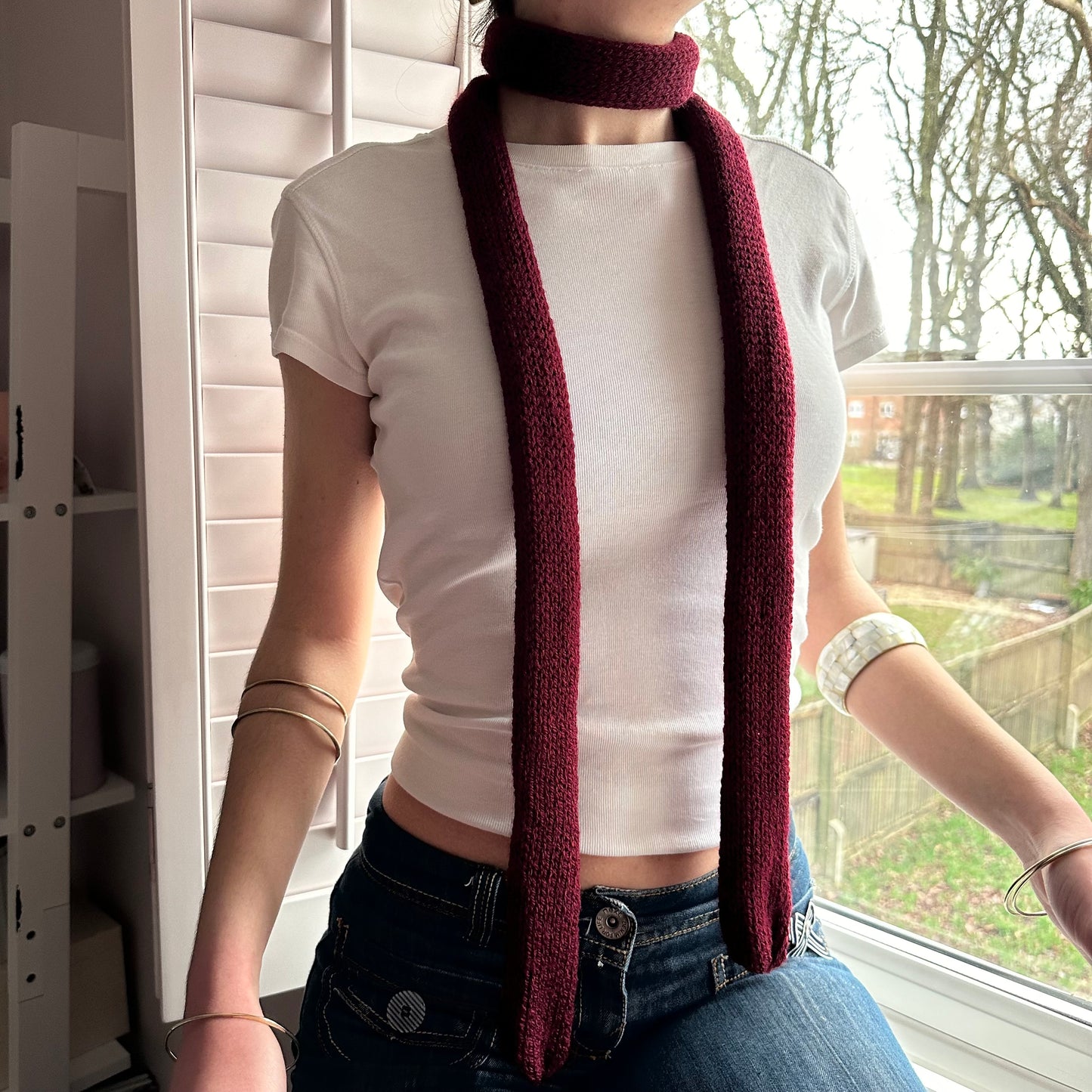 Handmade knitted skinny scarf in burgundy