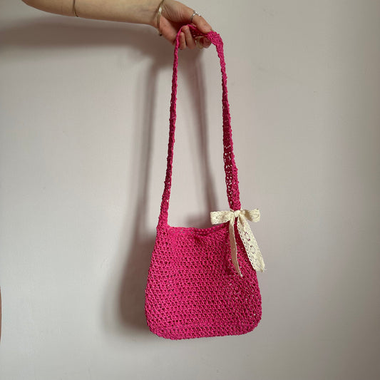 Handmade hot pink crochet straw bag with cream lace bow - can also be worn crossbody