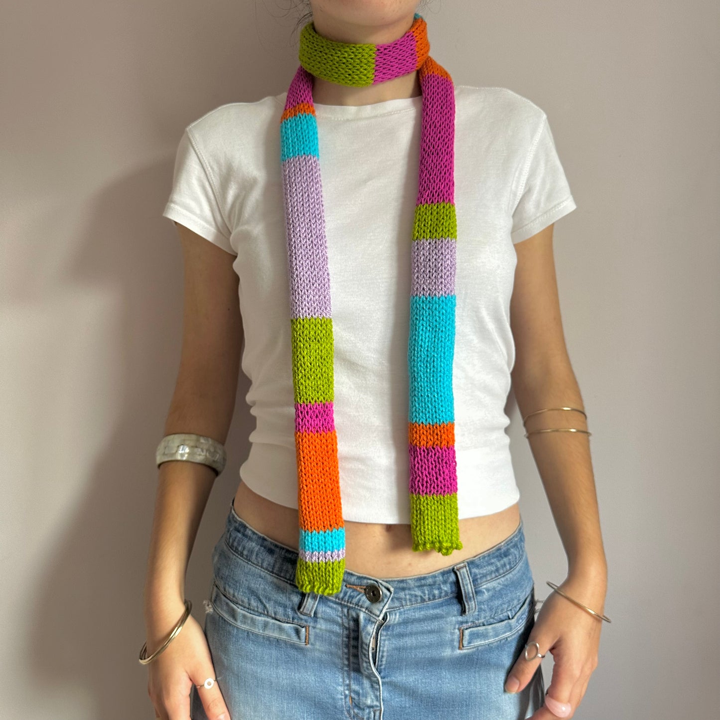 Handmade knitted stripy skinny scarf in orange, lilac, blue, green and pink