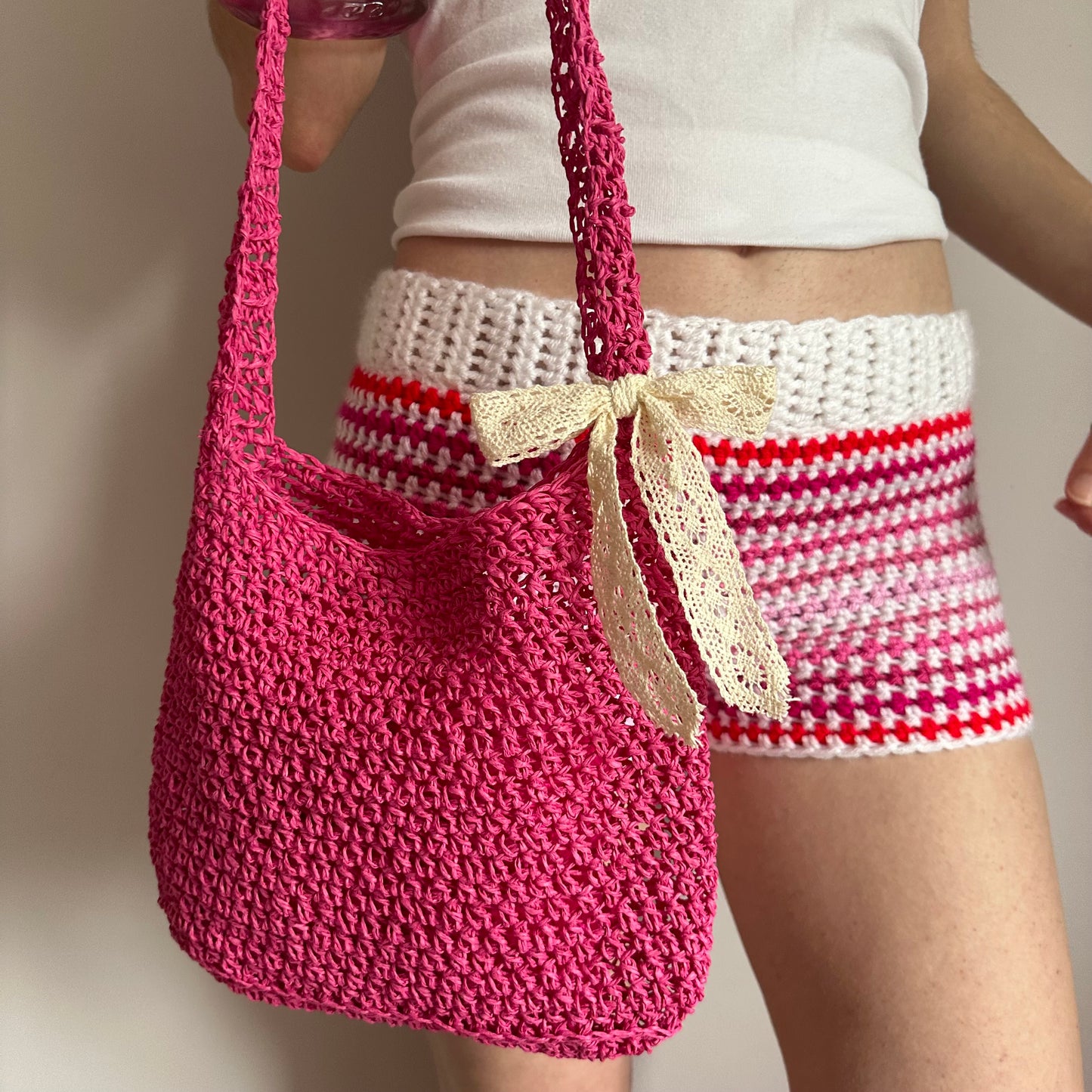 Handmade hot pink crochet straw bag with cream lace bow - can also be worn crossbody