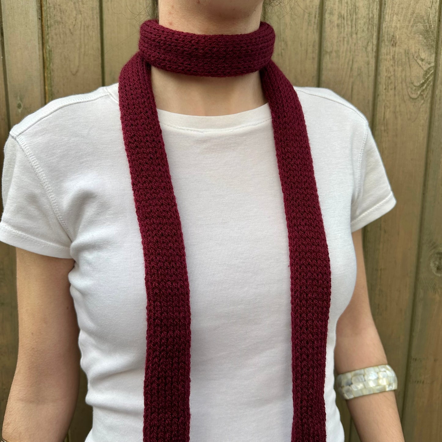 Handmade knitted skinny scarf in burgundy