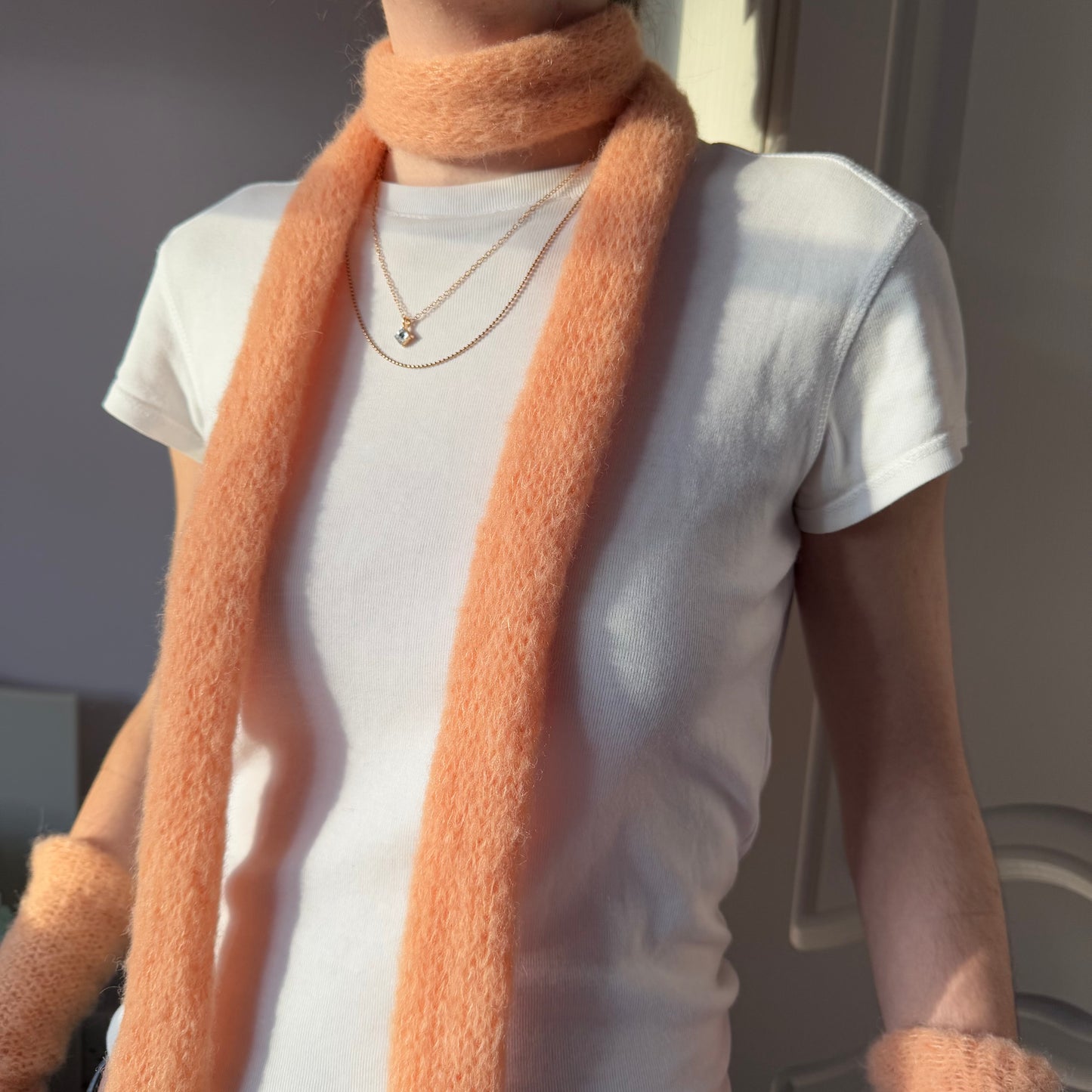 Handmade knitted mohair skinny scarf in light orange