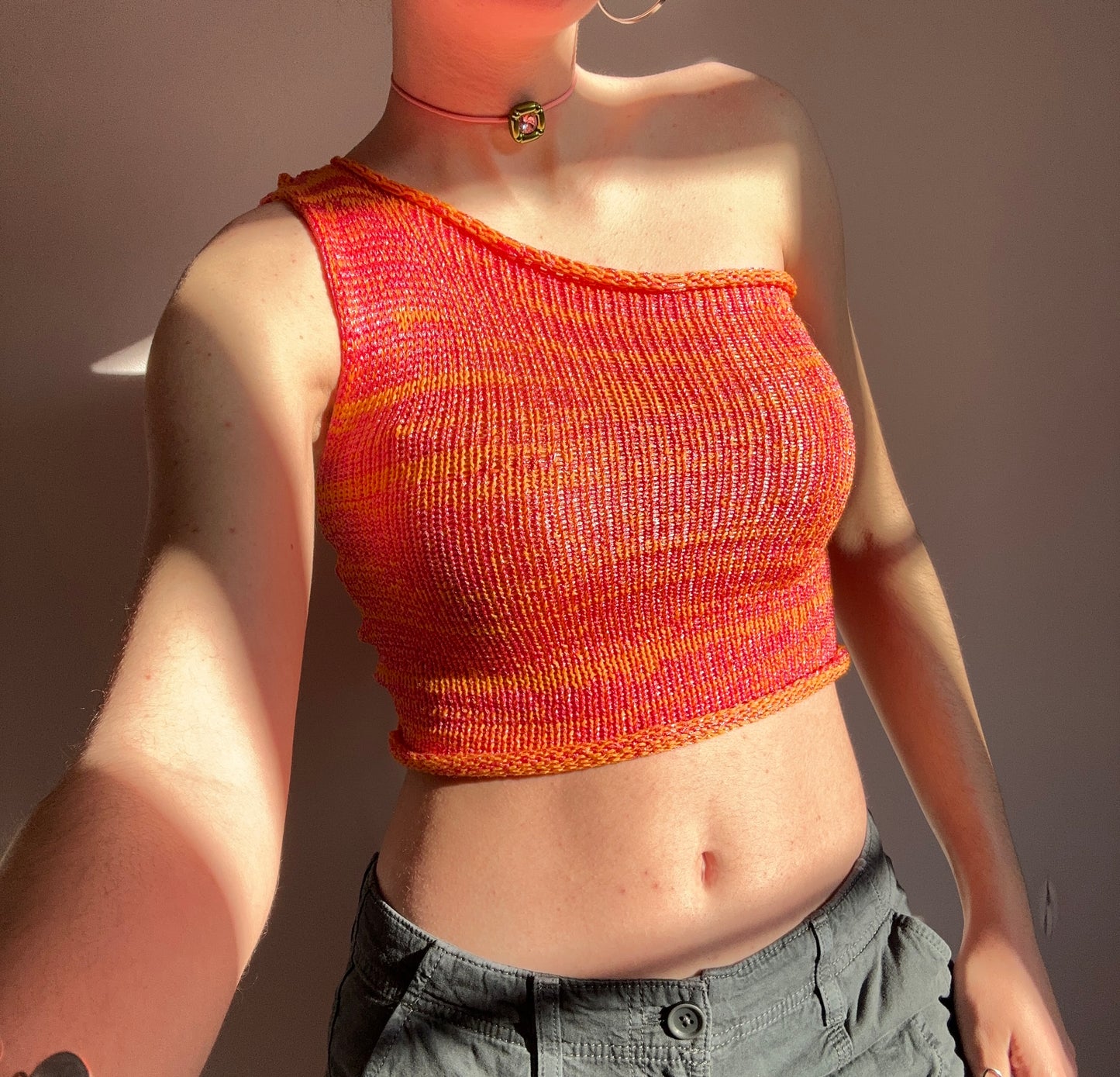 Handmade knitted metallic asymmetrical one shoulder top in orange and pink