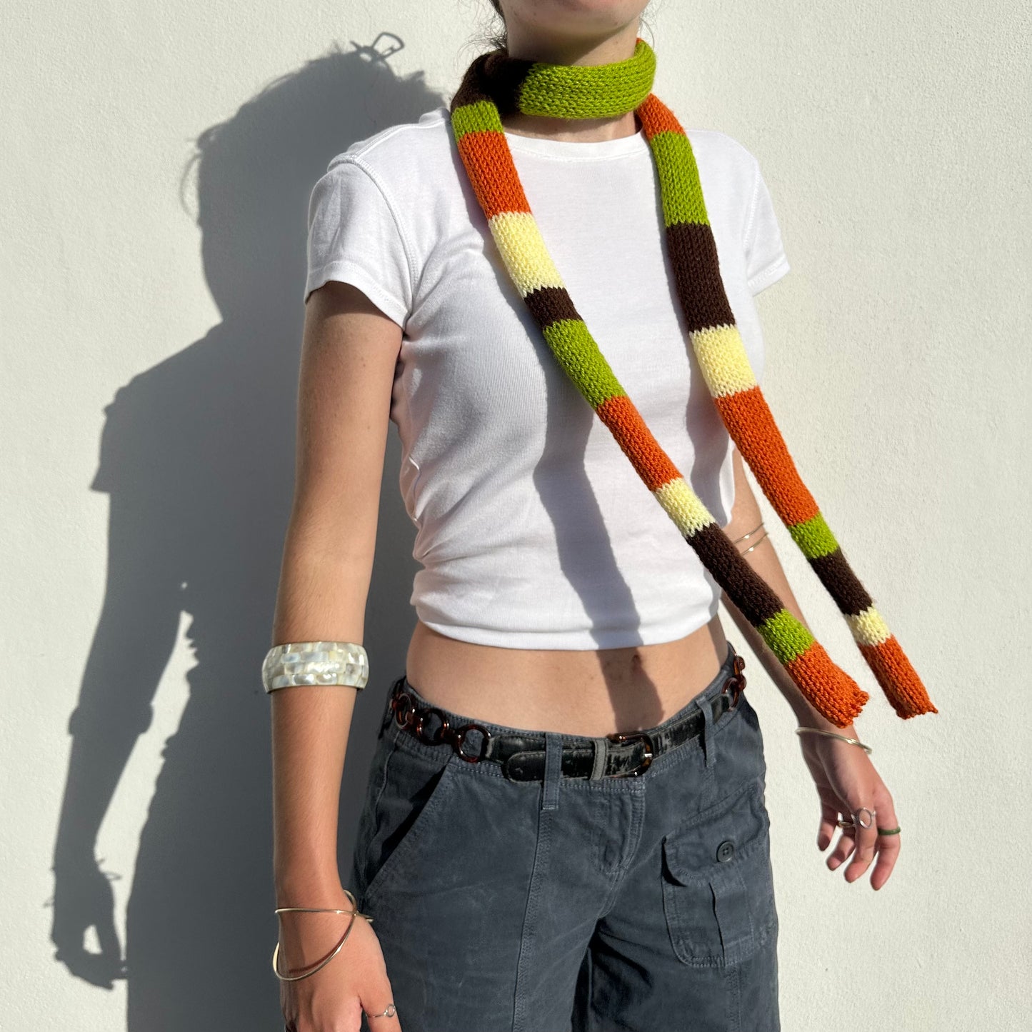 Handmade knitted stripy skinny scarf in orange, brown green and yellow