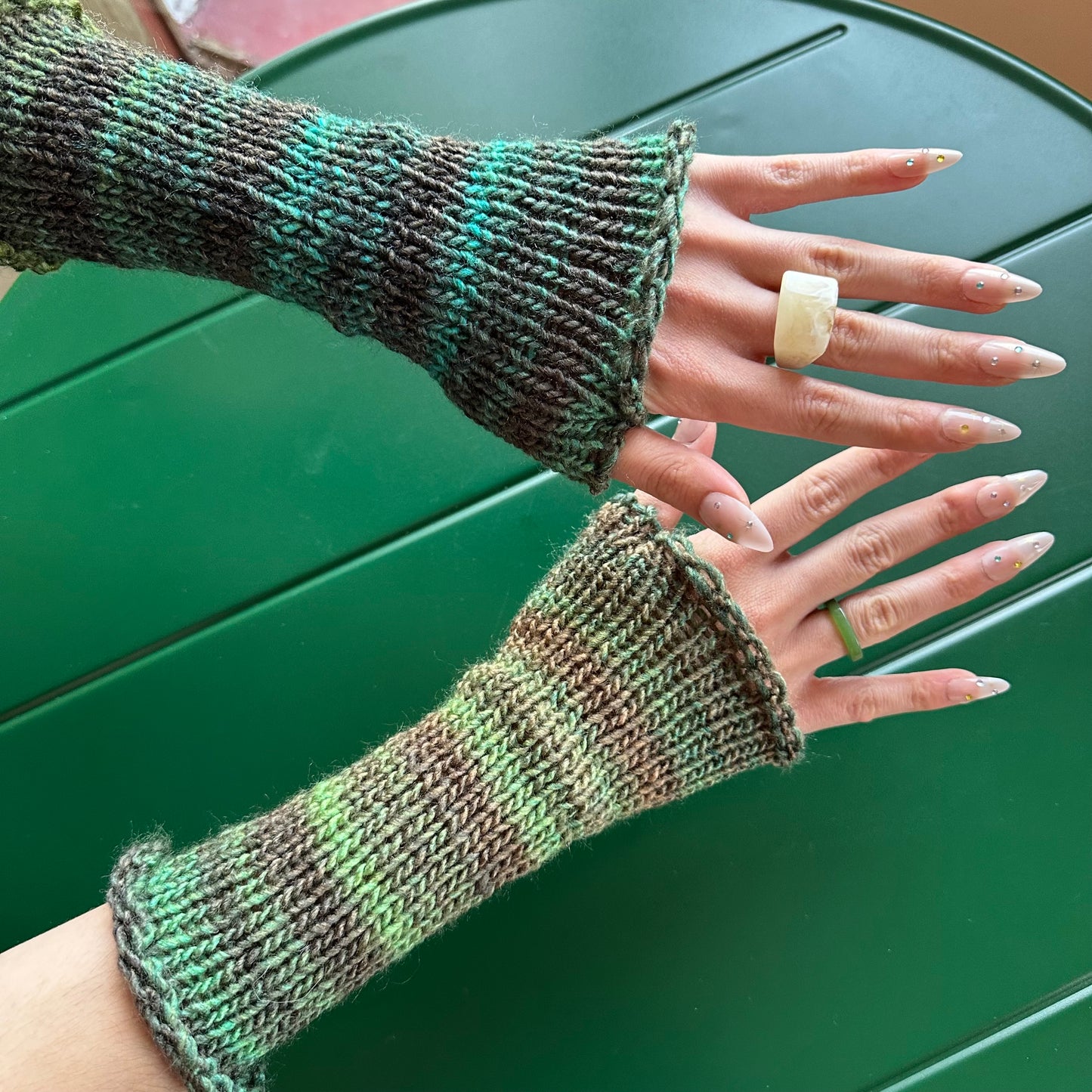 Handmade knitted ombré green hand warmers