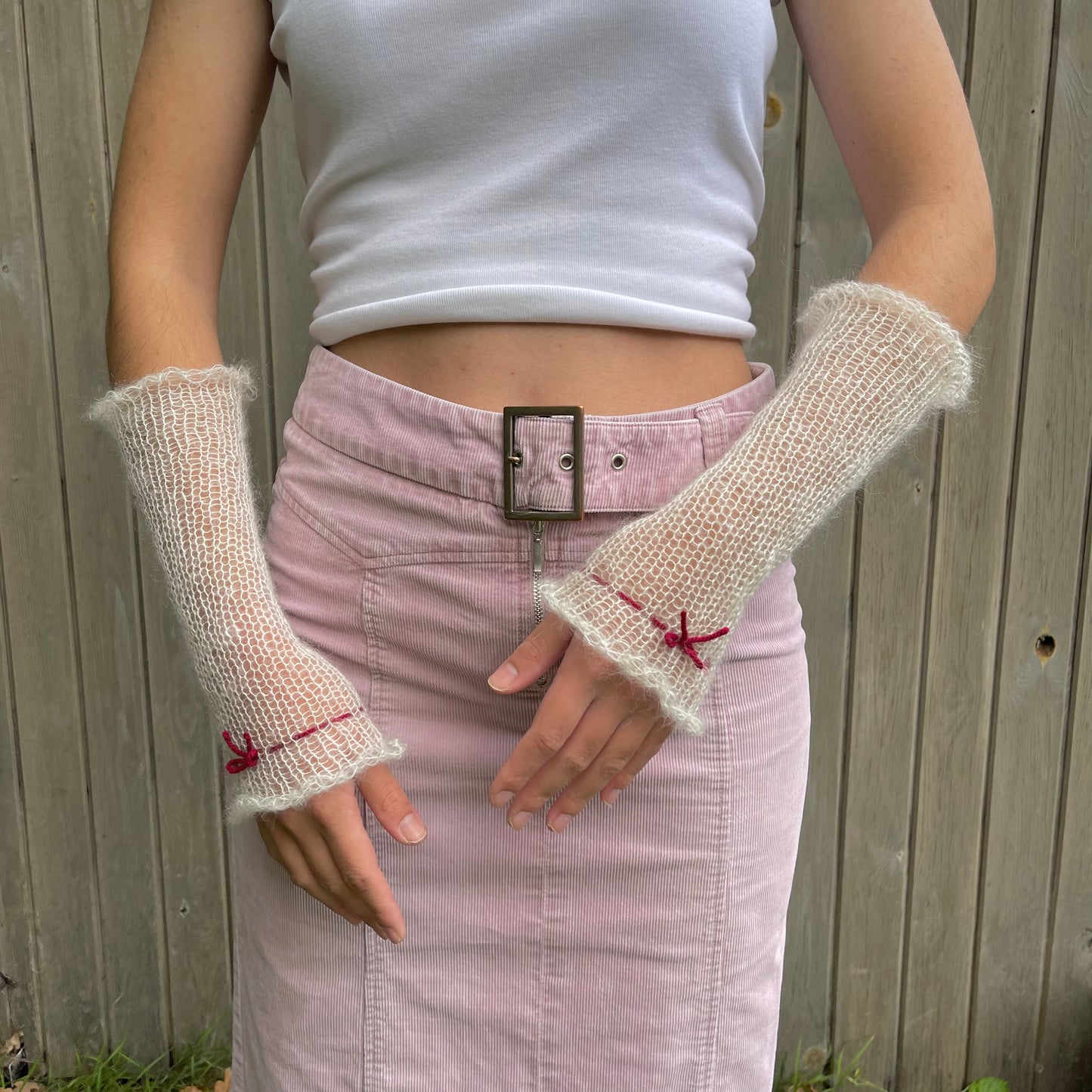 Handmade knitted mohair hand warmers in cream with dark red bow