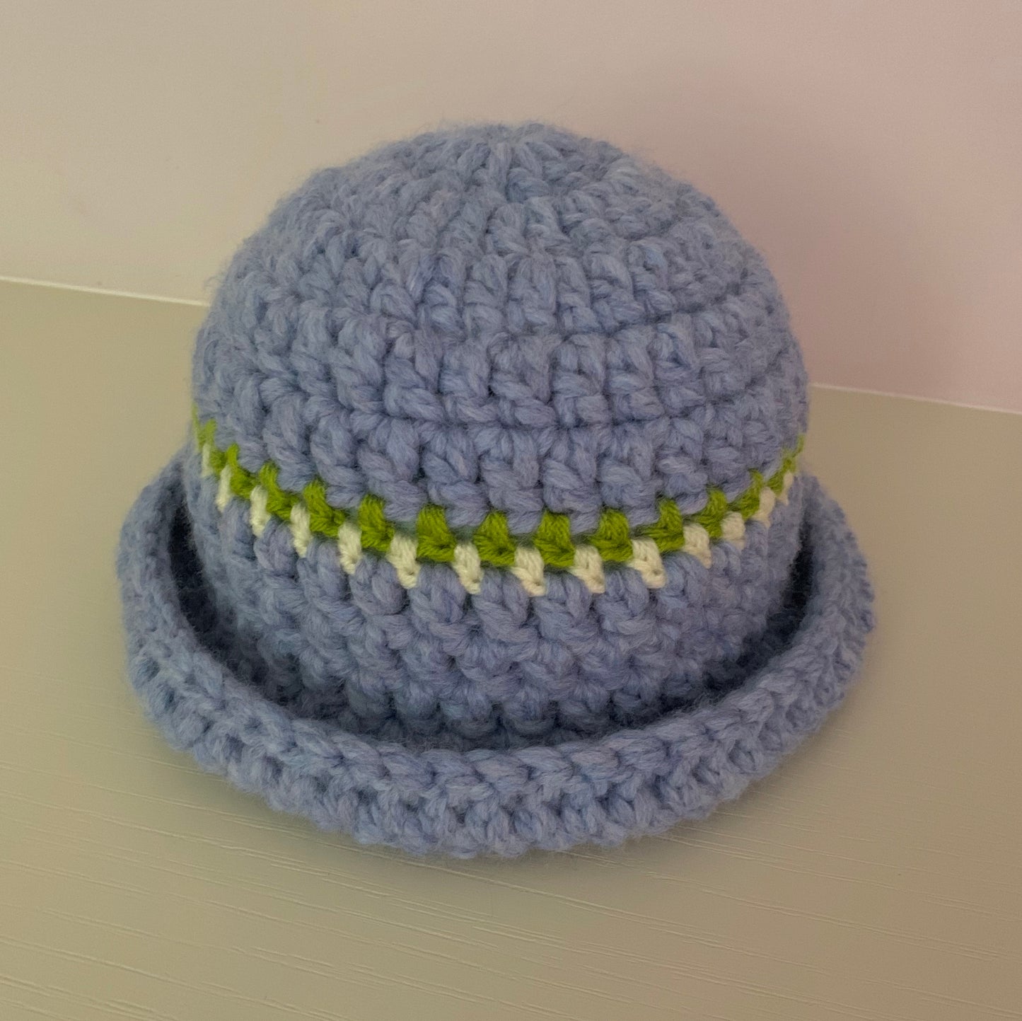 Handmade cornflower blue chunky crochet bowler hat with olive green and cream stripes