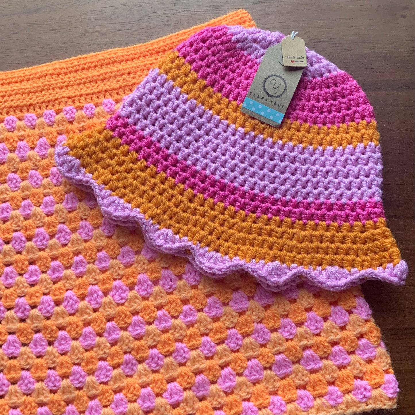 Handmade scallop edge crochet bucket hat in orange and pink