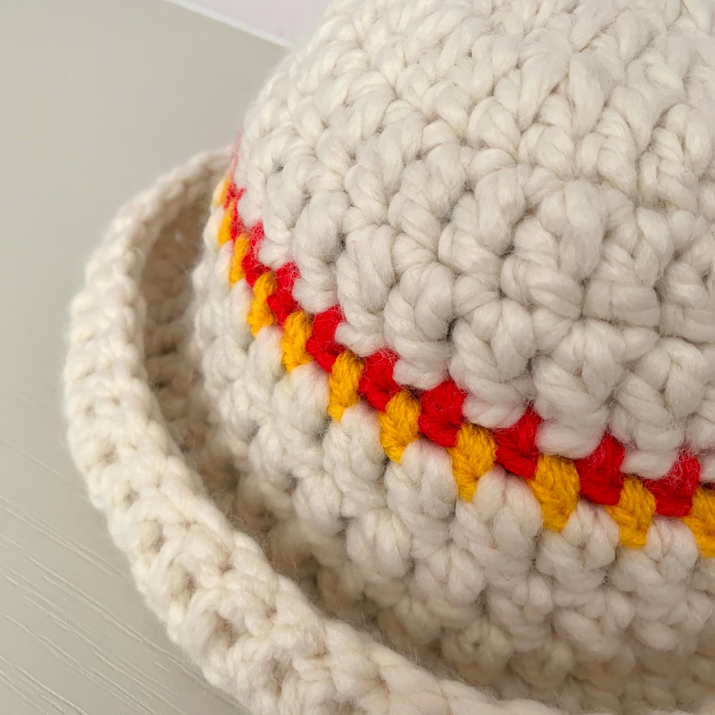 Handmade cream chunky bowler hat with red and yellow stripes