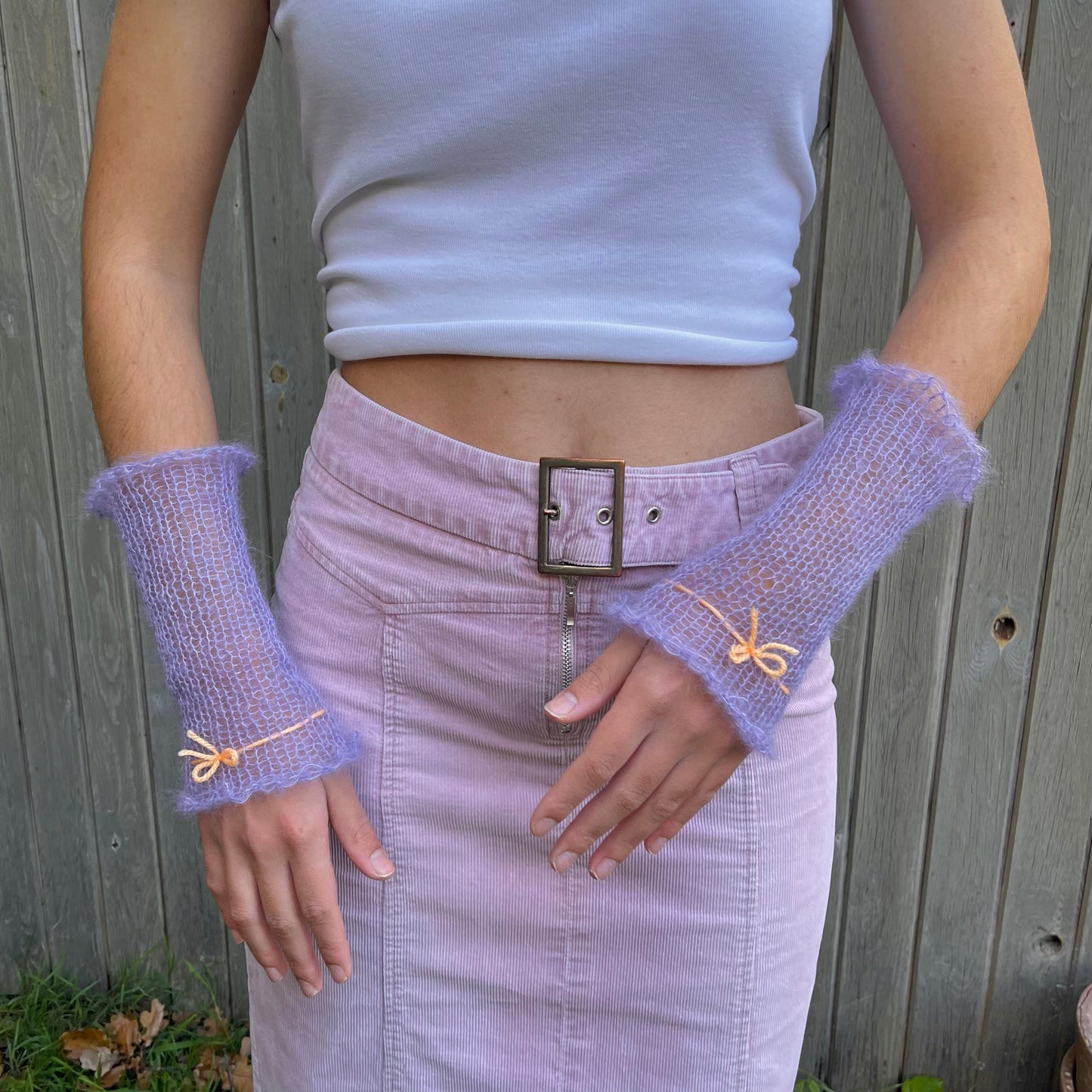 Handmade knitted mohair hand warmers in periwinkle with pastel orange bow