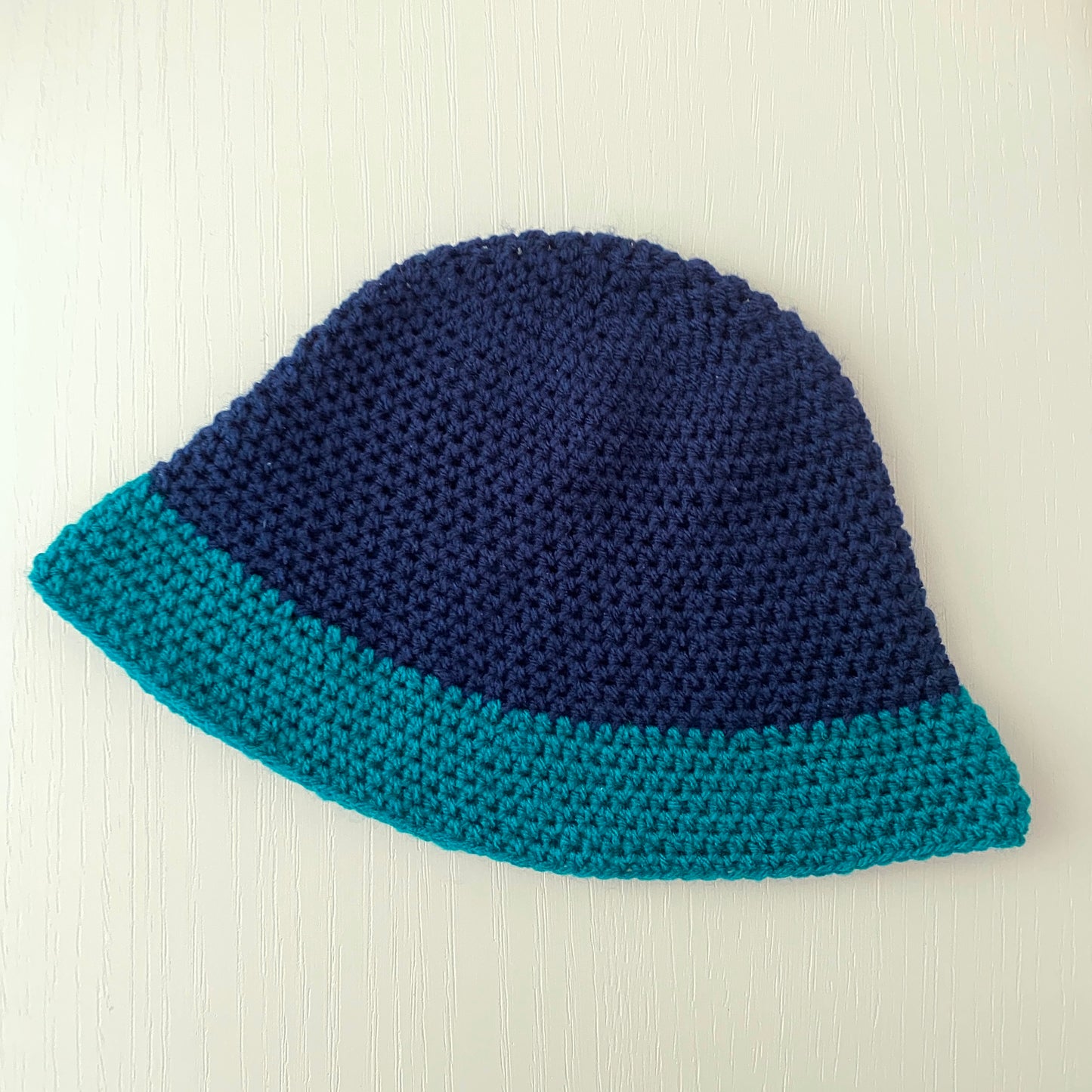 Handmade crochet colour block bucket hat in navy blue & teal