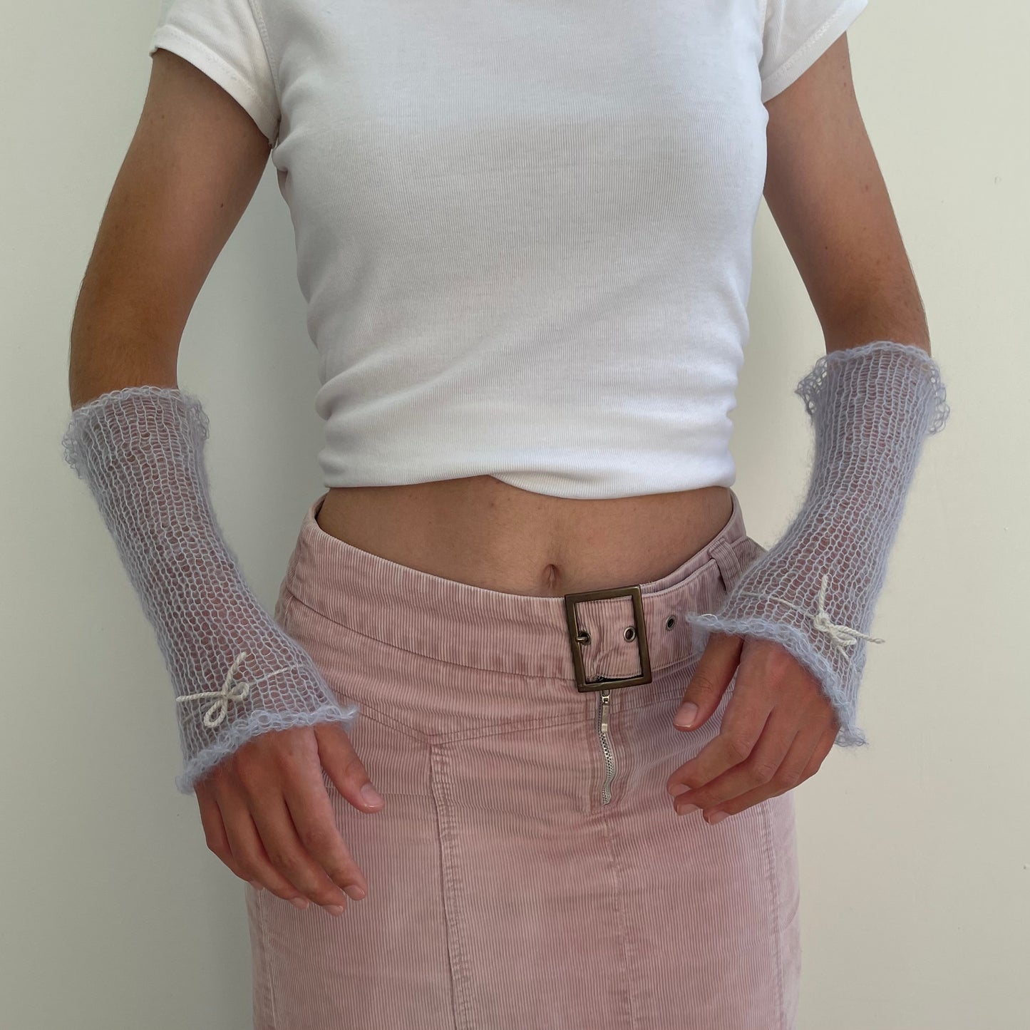 Handmade knitted mohair hand warmers in baby blue with beige bow