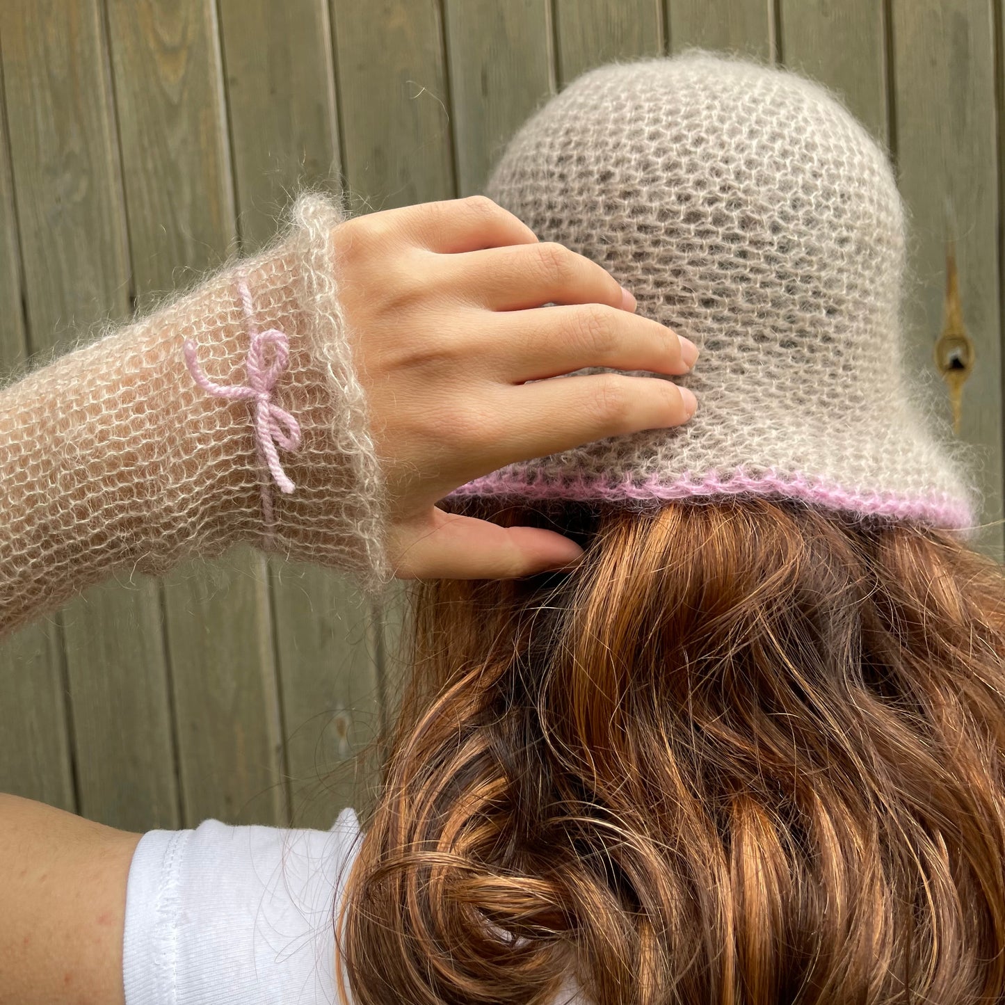 Handmade knitted mohair hand warmers in beige with dusky pink bow