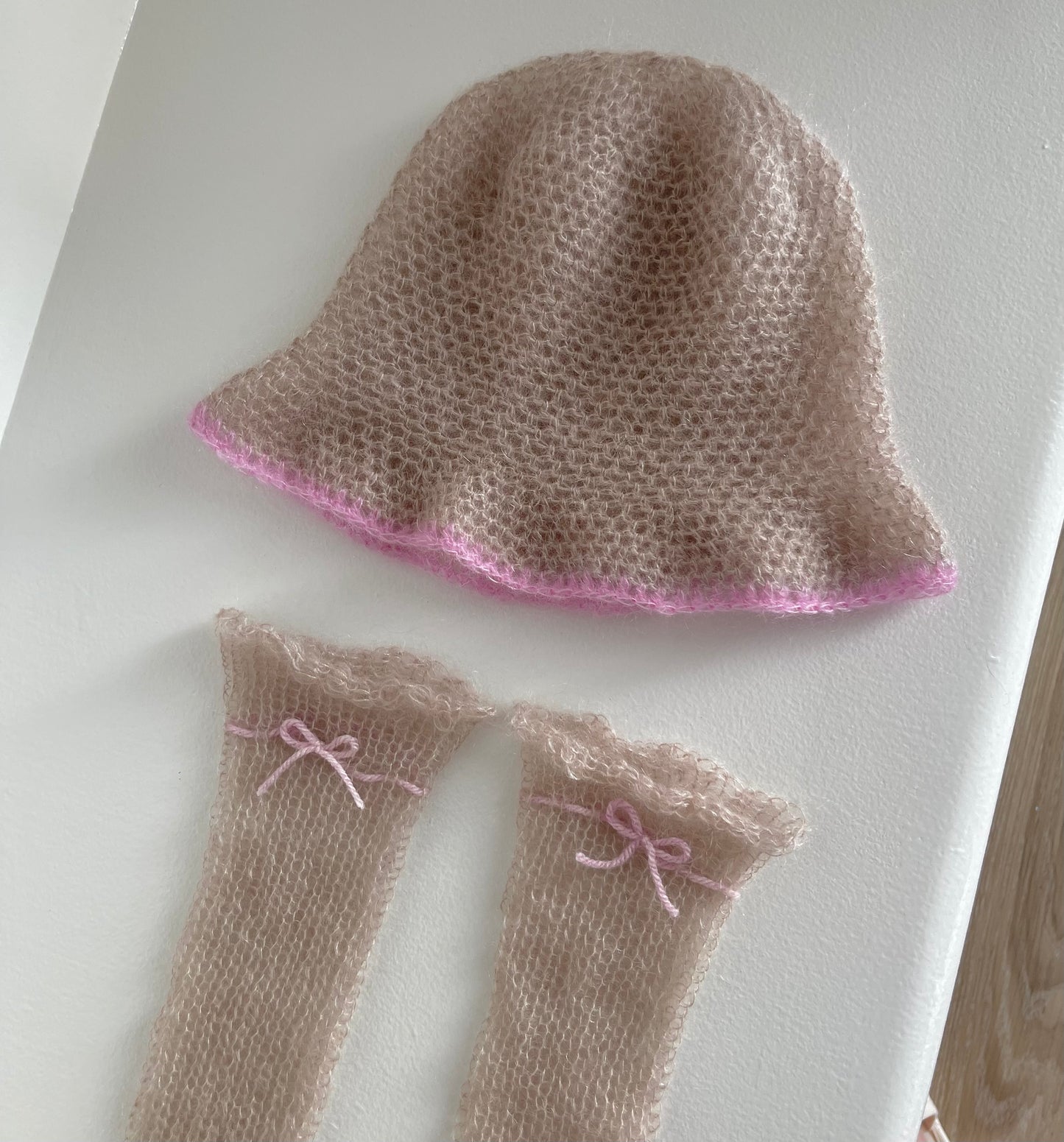 Handmade knitted mohair hand warmers in beige with dusky pink bow