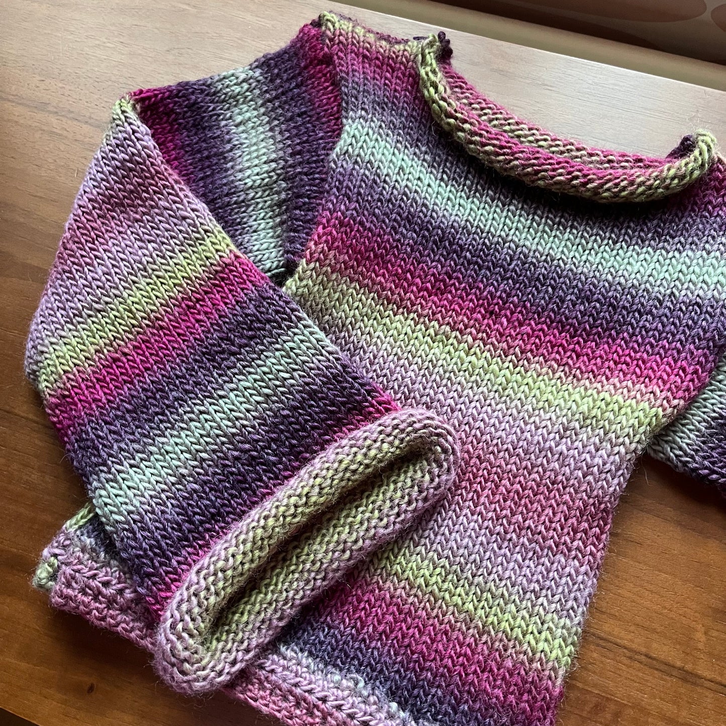 Handmade ombré knitted flared sleeve jumper in green and purple shades