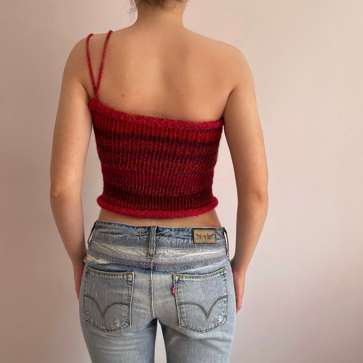 Handmade knitted asymmetrical top in red tones