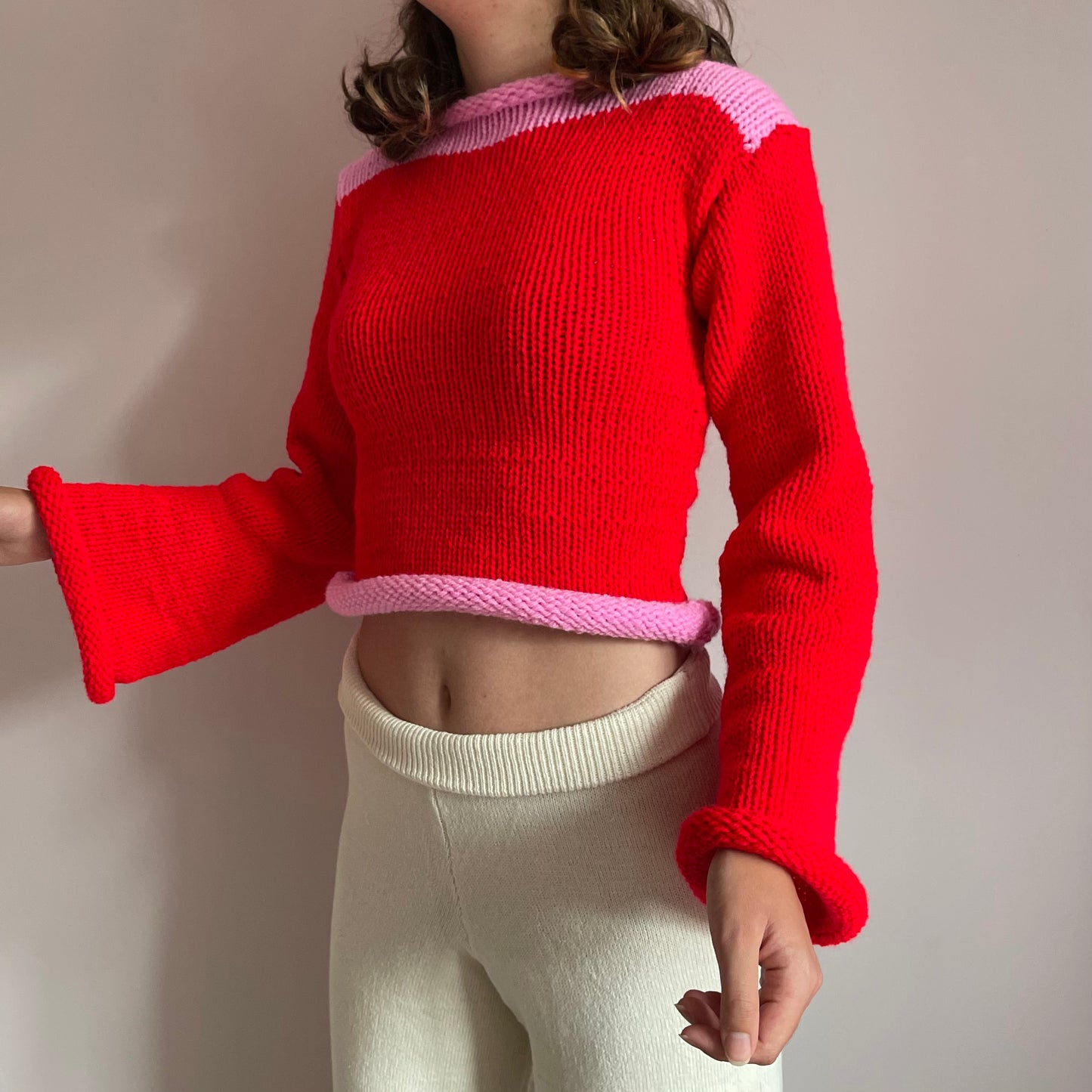 Handmade knitted colour block jumper in red and pink